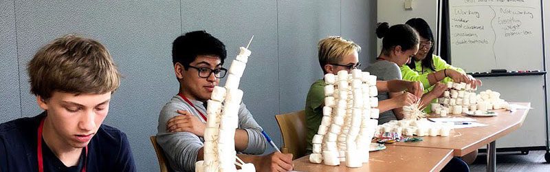 Teens building marshmallow towers