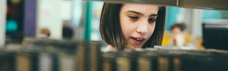 Child browsing shelves