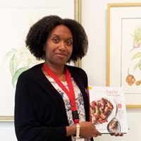 Librarian Juanita Harrell with healthy cookbook