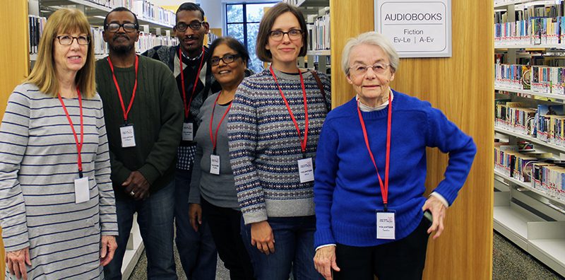 Library volunteers standing in the stacks