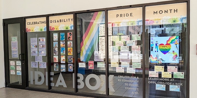 Display for Disability Pride Month in the windows of the Main Library Idea Box