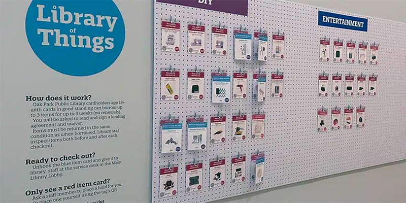 Pegboard wall with hanging tags and text that says "Library of Things"