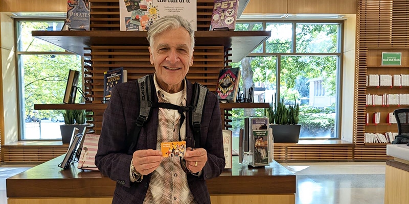 New library cardholder holding an Oak Park library card