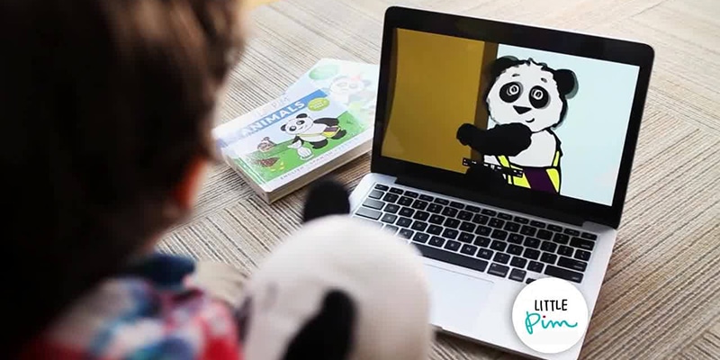 Child watching LIttle Pim video featuring a cartoon panda on laptop screen