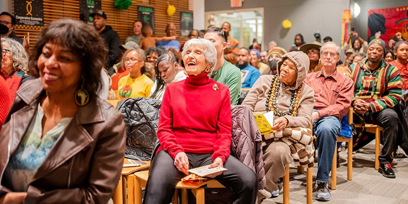 Delighted faces among audience members in the Main Library Veterans Room